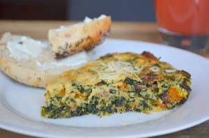 Ricotta tart full of spinach, peppers and a touch of ham & bacon served alongside half an everything bagel from Sammy's New York Bagels.